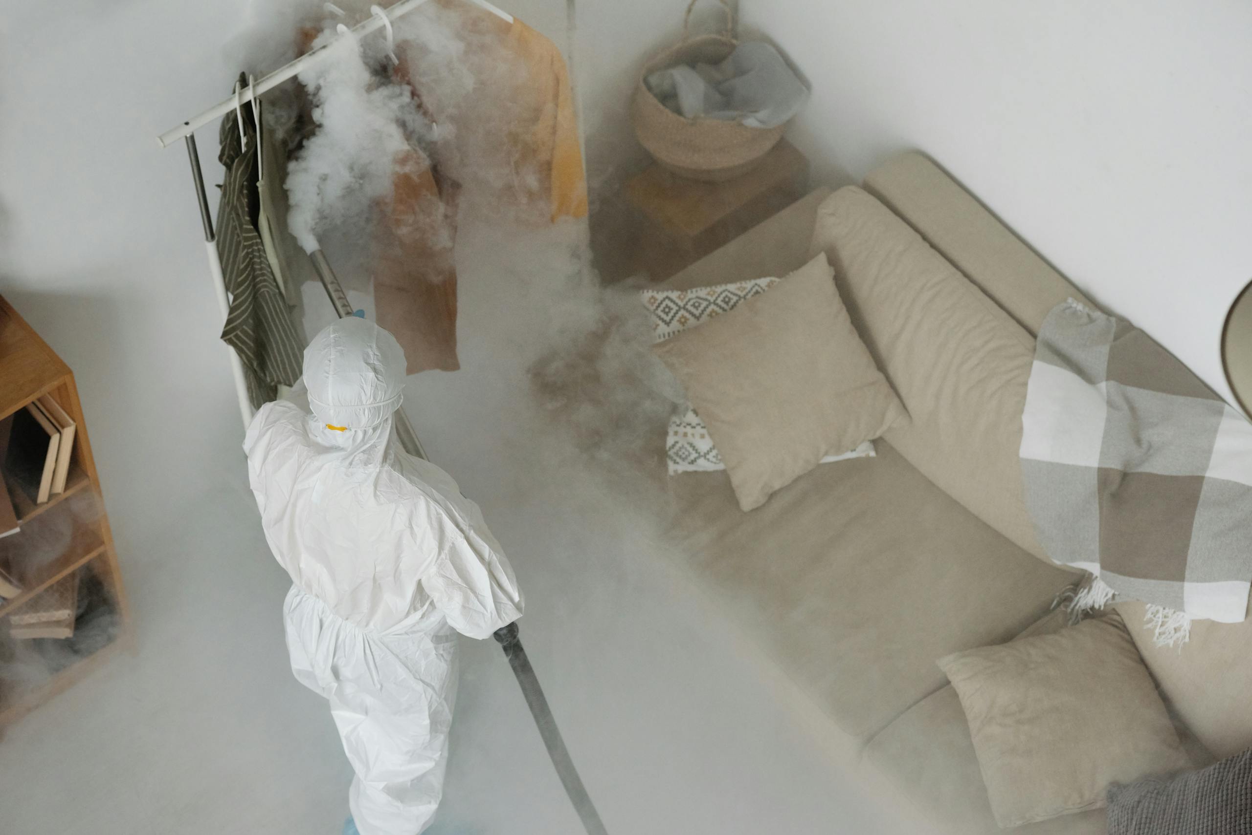 Person Wearing Personal Protective Equipment Fumigating Indoor